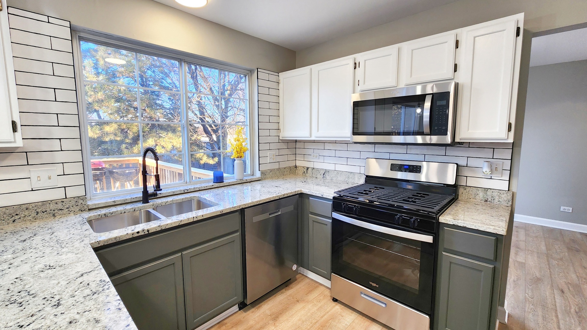 1296 Spaulding Road Bartlett, IL 60103 - Photo 8 of 37 a kitchen with stainless steel appliances a stove sink and microwave