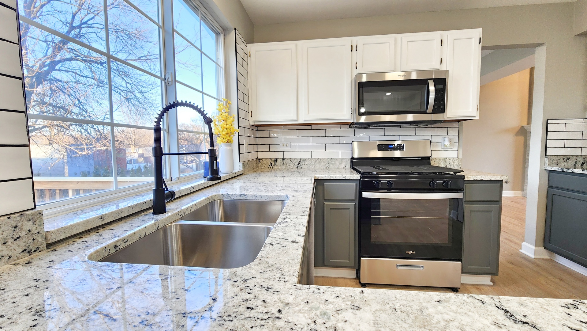 1296 Spaulding Road Bartlett, IL 60103 - Photo 9 of 37 a kitchen with a sink a stove and microwave