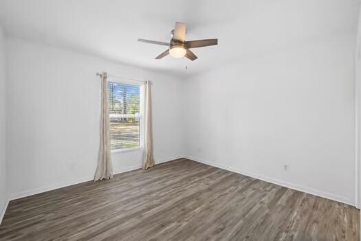 30 Lowery Road Freeport, FL 32439 - Photo 17 of 40 an empty room with wooden floor chandelier fan and windows