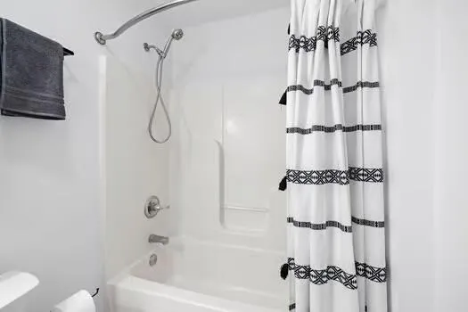 a bathroom with a bathtub shower