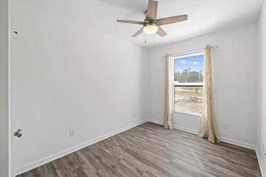 30 Lowery Road Freeport, FL 32439 - Photo 23 of 40 an empty room with wooden floor fan and windows