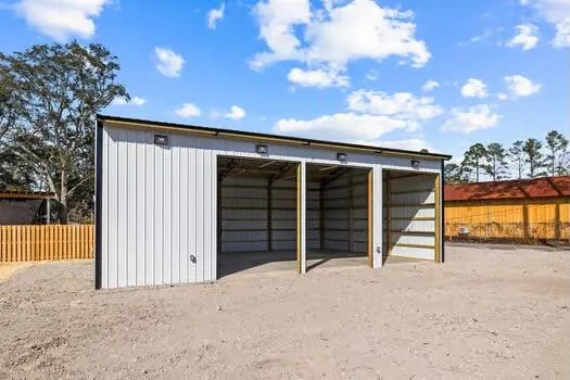 a view of a house with a wooden fence