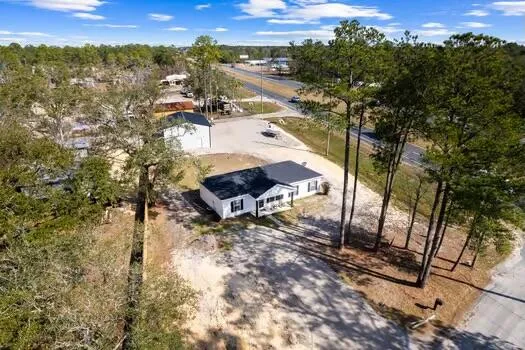 a view of a house with a yard and sitting area