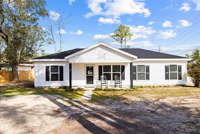 30 Lowery Road Freeport, FL 32439 - Photo 5 of 40 a front view of a house with swimming pool and porch with furniture