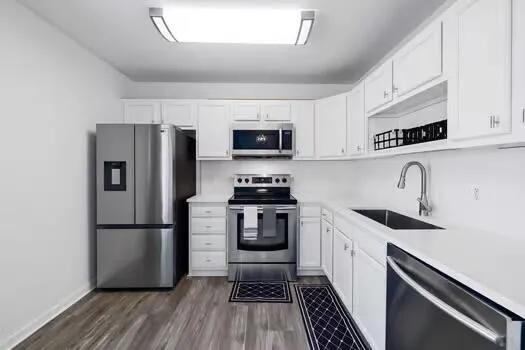a kitchen with a refrigerator a sink and a stove