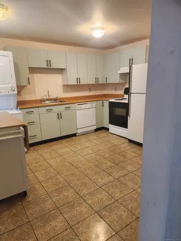 a kitchen with stainless steel appliances a refrigerator sink and cabinets