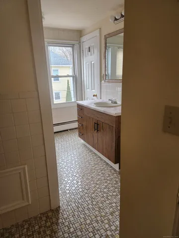a bathroom with a sink a toilet and window