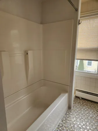 a bathroom with a bathtub and a shower