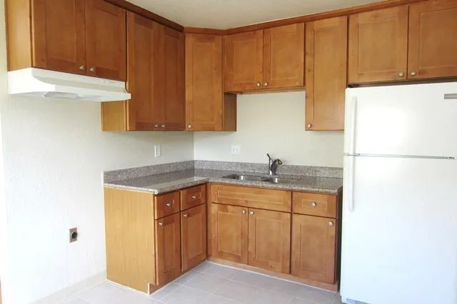 a kitchen with a sink cabinets and a refrigerator