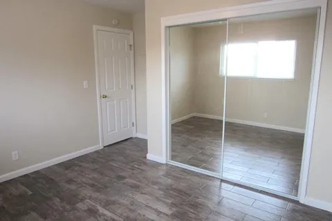 an empty room with wooden floor