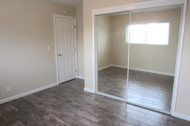 an empty room with wooden floor