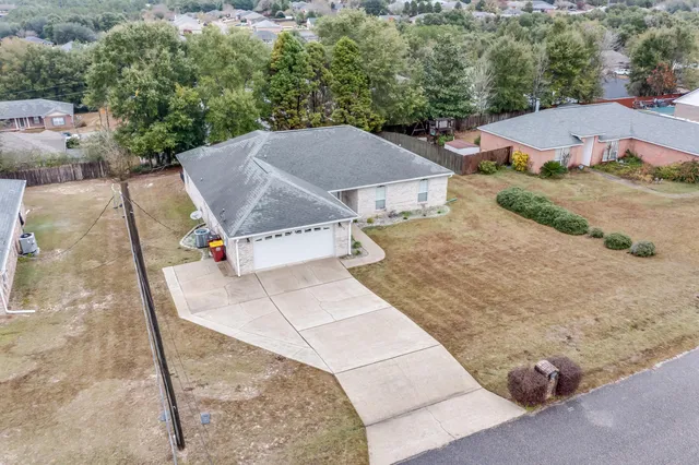 an aerial view of a house with a yard