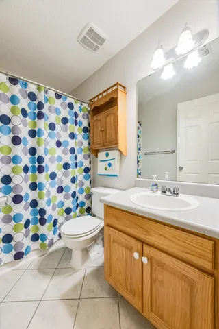 a bathroom with a sink toilet and a mirror