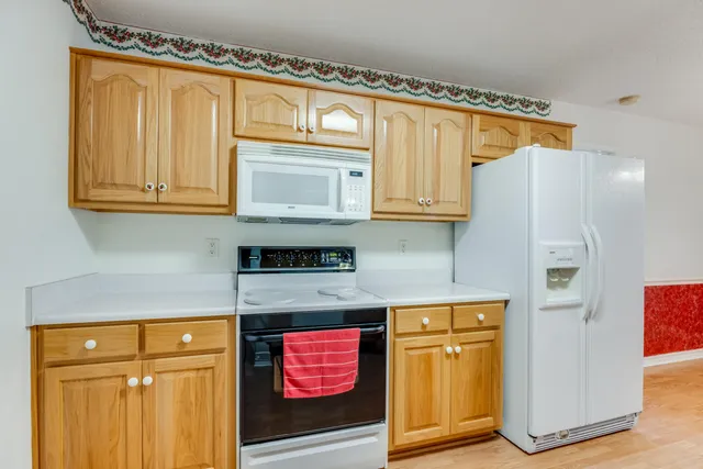 a kitchen with stainless steel appliances granite countertop cabinets and a refrigerator