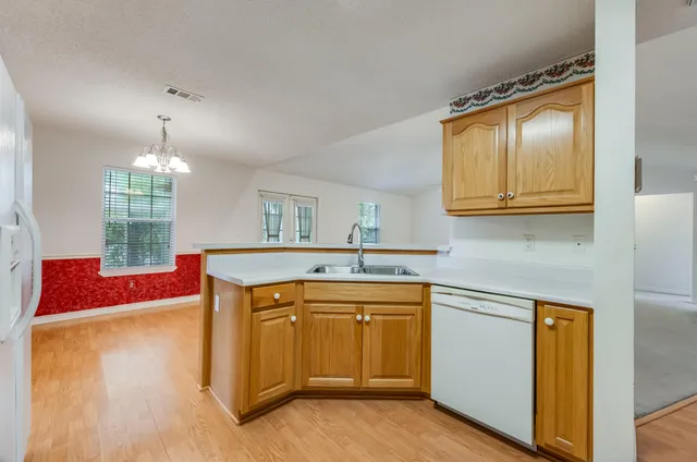 a room with stainless steel appliances a sink dishwasher stove and refrigerator