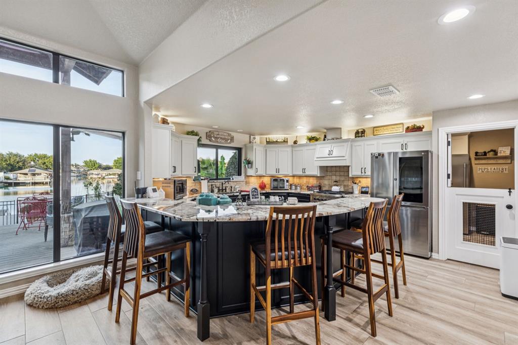 2325 River Road Granbury, TX 76048 - Photo 14 of 40 a view of a dining area with furniture window and wooden floor