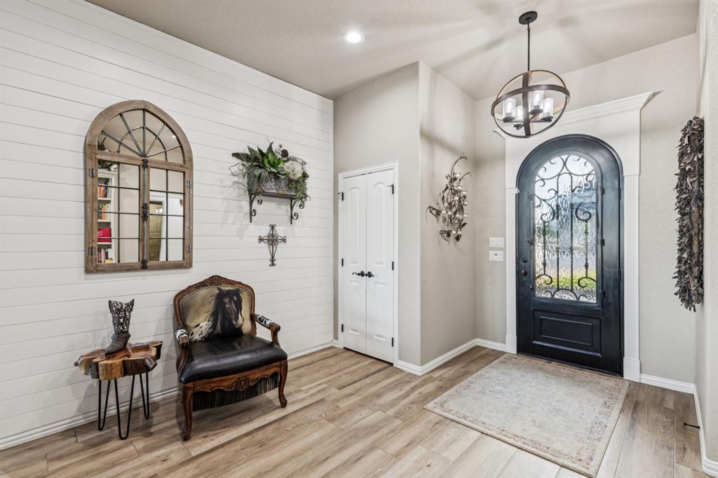 2325 River Road Granbury, TX 76048 - Photo 18 of 40 a view of a livingroom with furniture wooden floor a chandelier