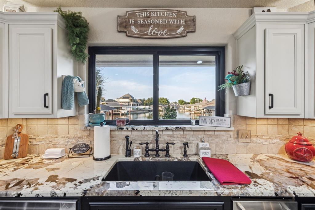 2325 River Road Granbury, TX 76048 - Photo 19 of 40 a kitchen with a stove a sink and cabinets