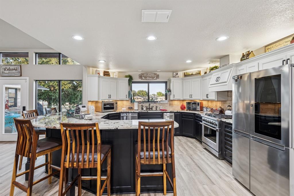 2325 River Road Granbury, TX 76048 - Photo 24 of 40 a view of a dining area with furniture window and wooden floor