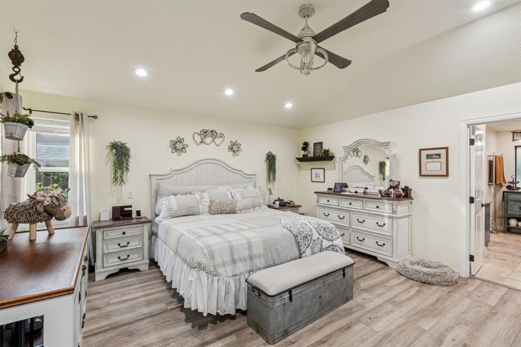2325 River Road Granbury, TX 76048 - Photo 29 of 40 a bedroom with a bed and ceiling fan