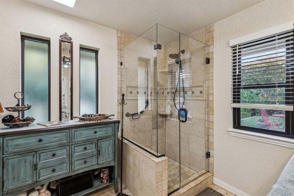 2325 River Road Granbury, TX 76048 - Photo 31 of 40 a bathroom with a shower sink and mirror