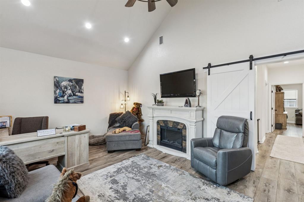 2325 River Road Granbury, TX 76048 - Photo 32 of 40 a living room with furniture and a fireplace