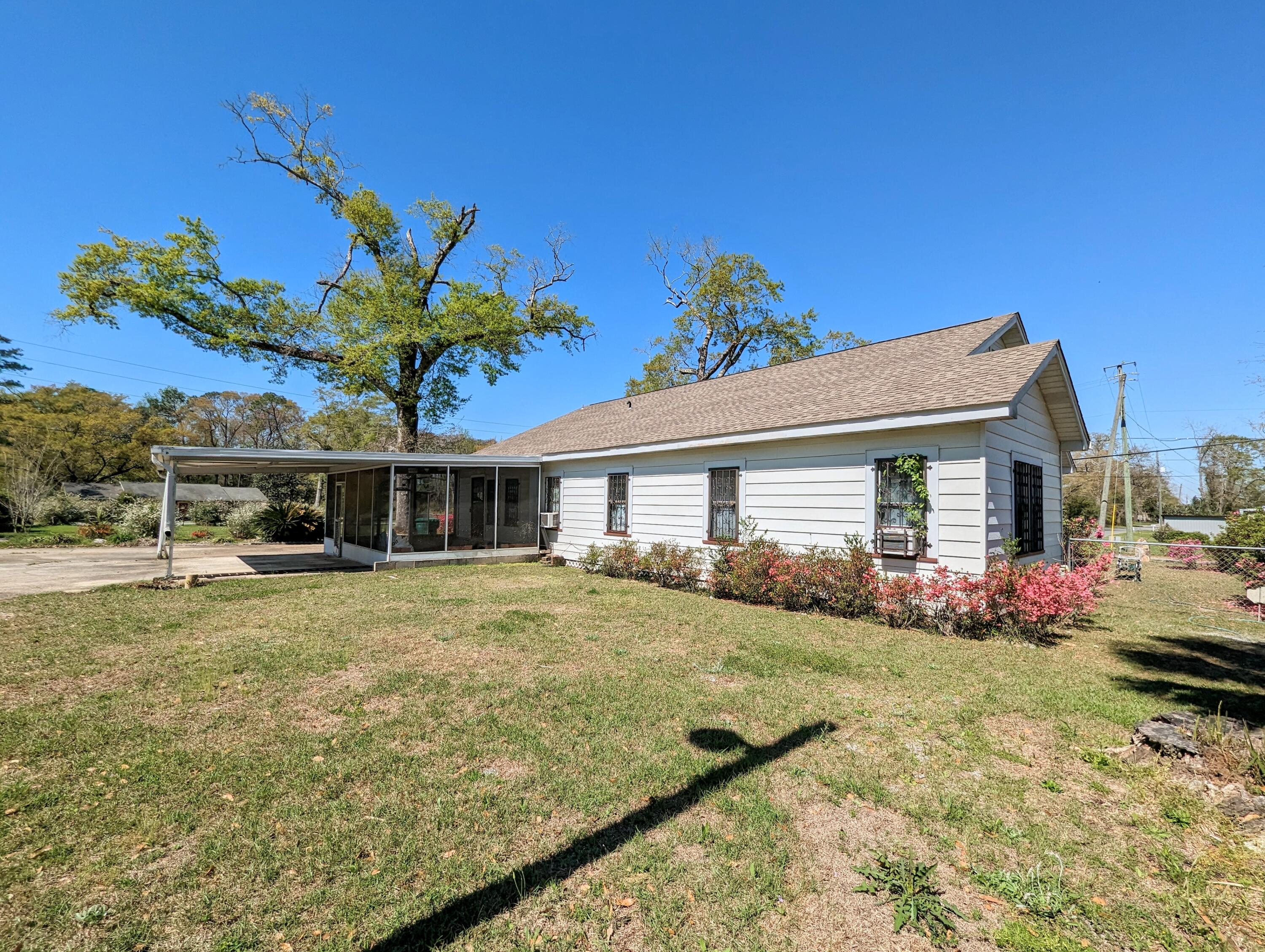 1335 Old Bonifay Road Chipley, FL 32428 - Photo 15 of 31 a front view of a house with a garden and yard