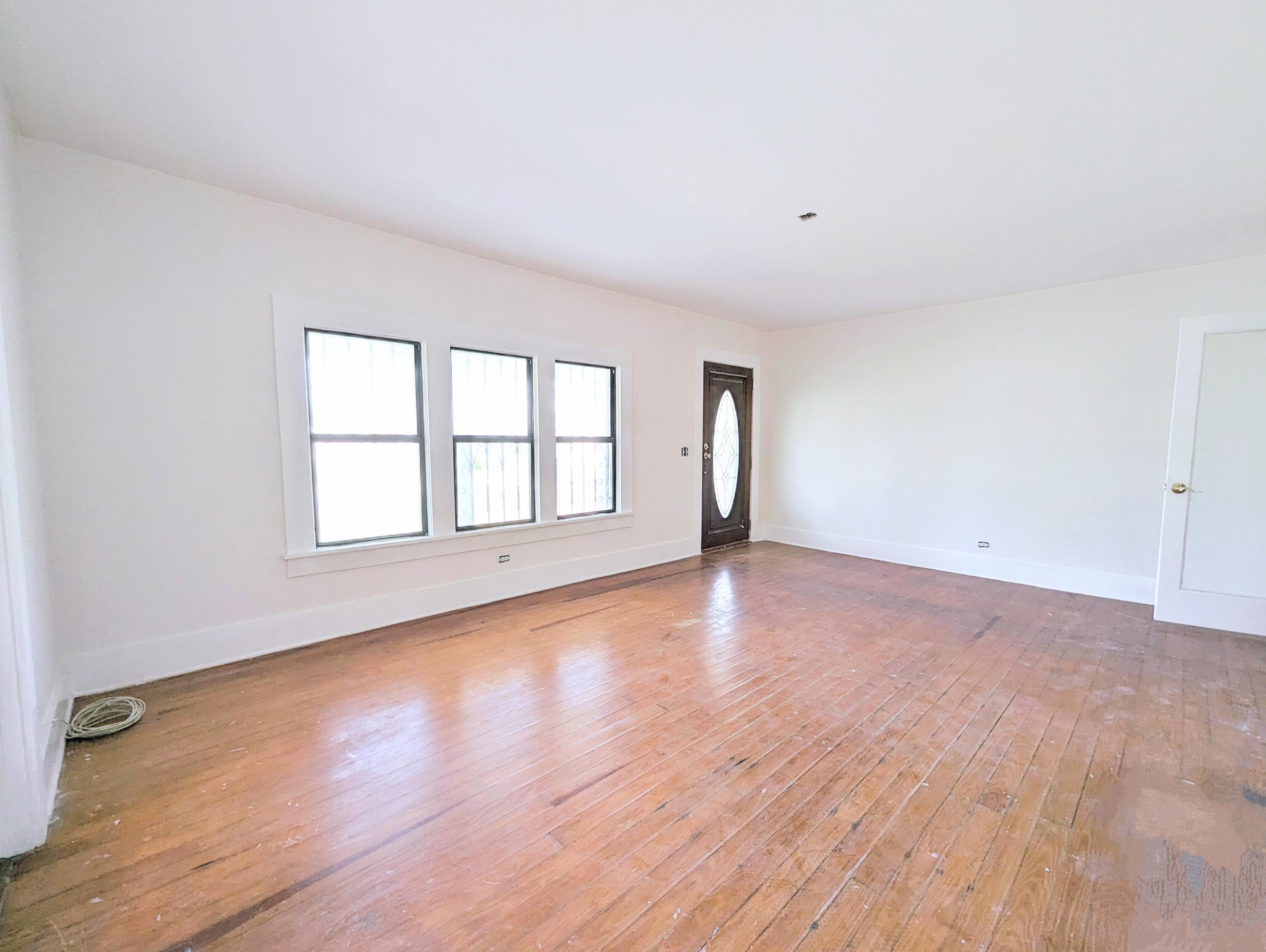 1335 Old Bonifay Road Chipley, FL 32428 - Photo 16 of 31 a view of an empty room with wooden floor and window