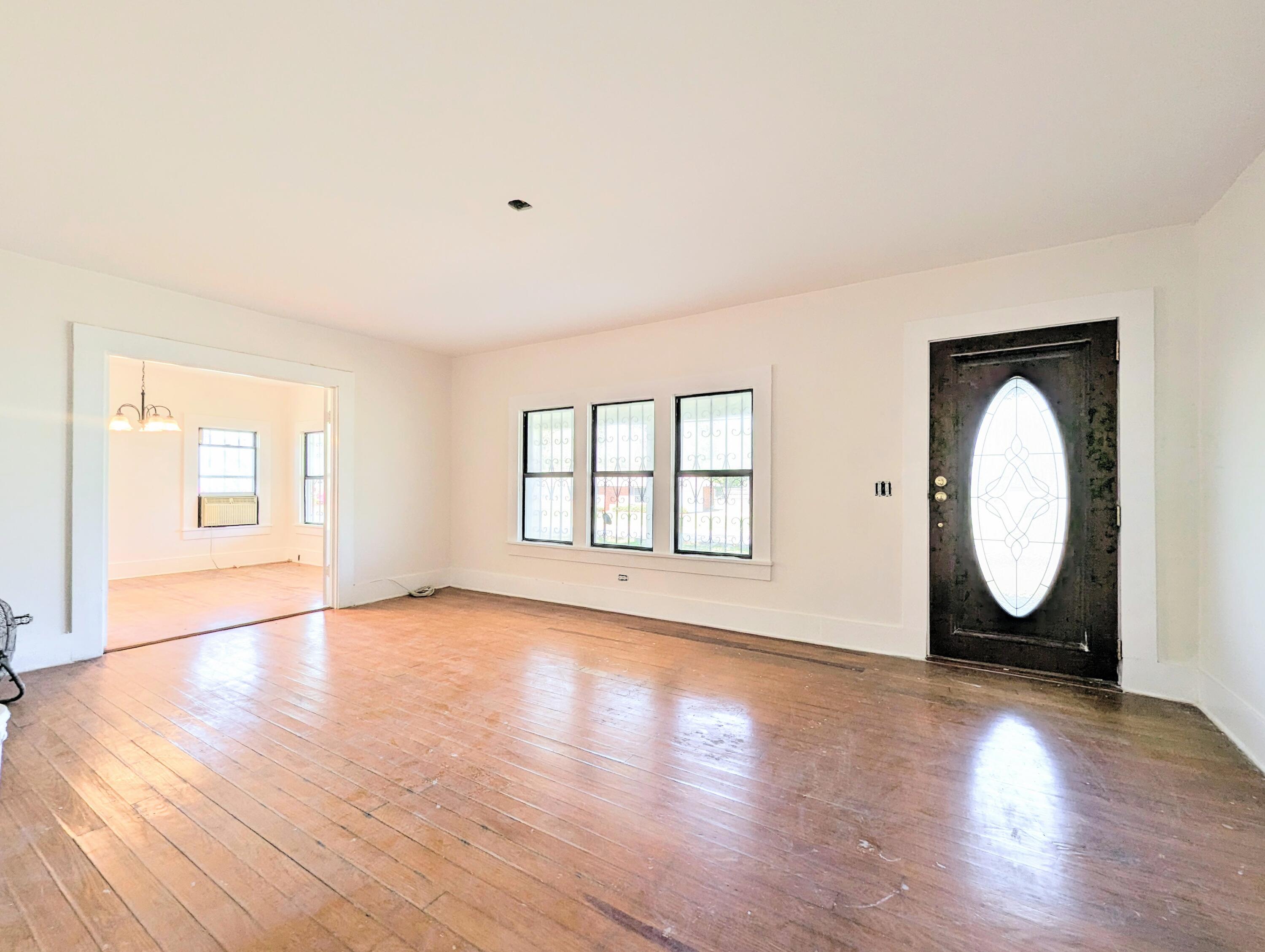 1335 Old Bonifay Road Chipley, FL 32428 - Photo 18 of 31 an empty room with wooden floor mirror and windows