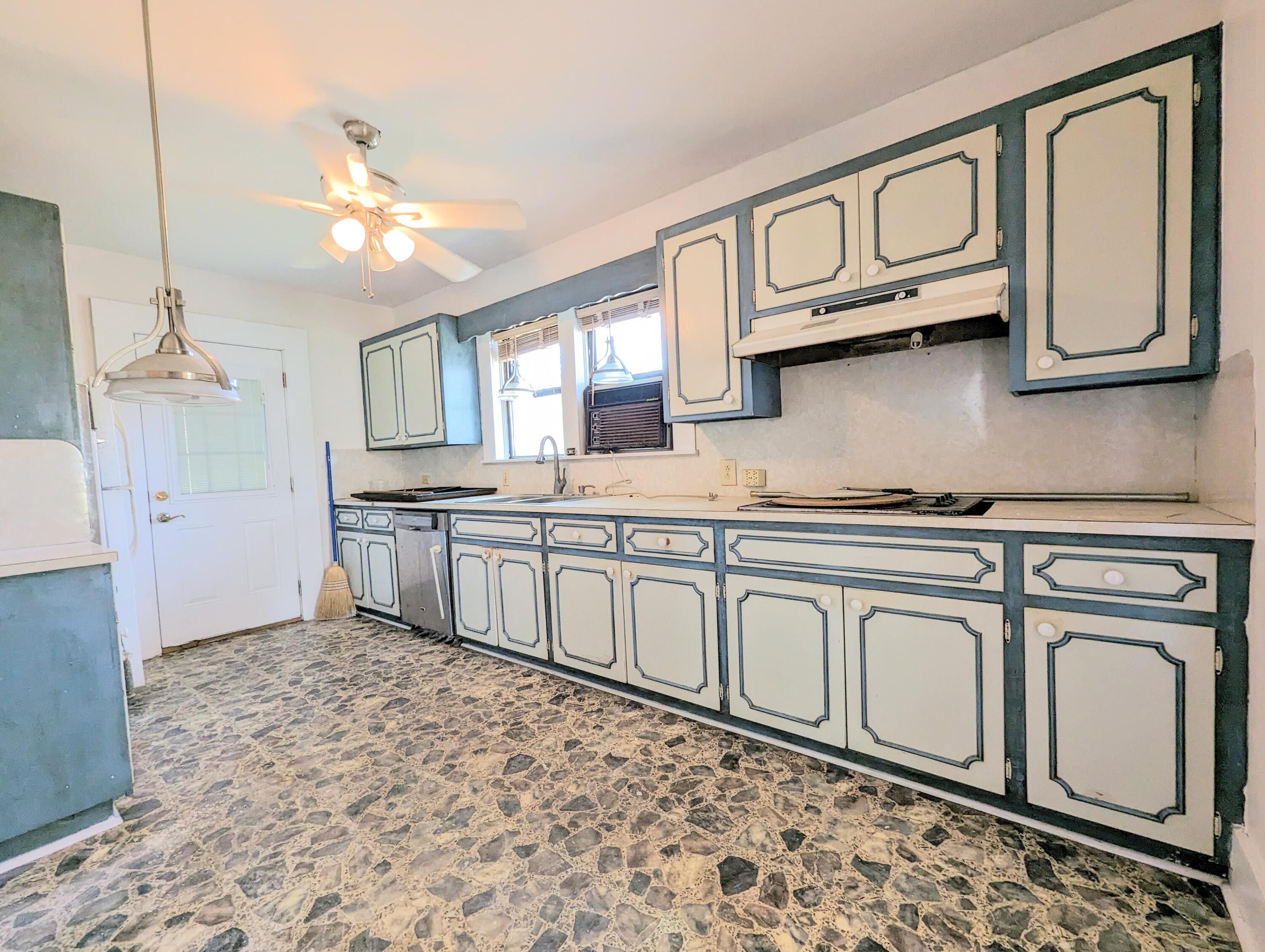 1335 Old Bonifay Road Chipley, FL 32428 - Photo 20 of 31 a kitchen with stainless steel appliances granite countertop a stove a sink and a microwave