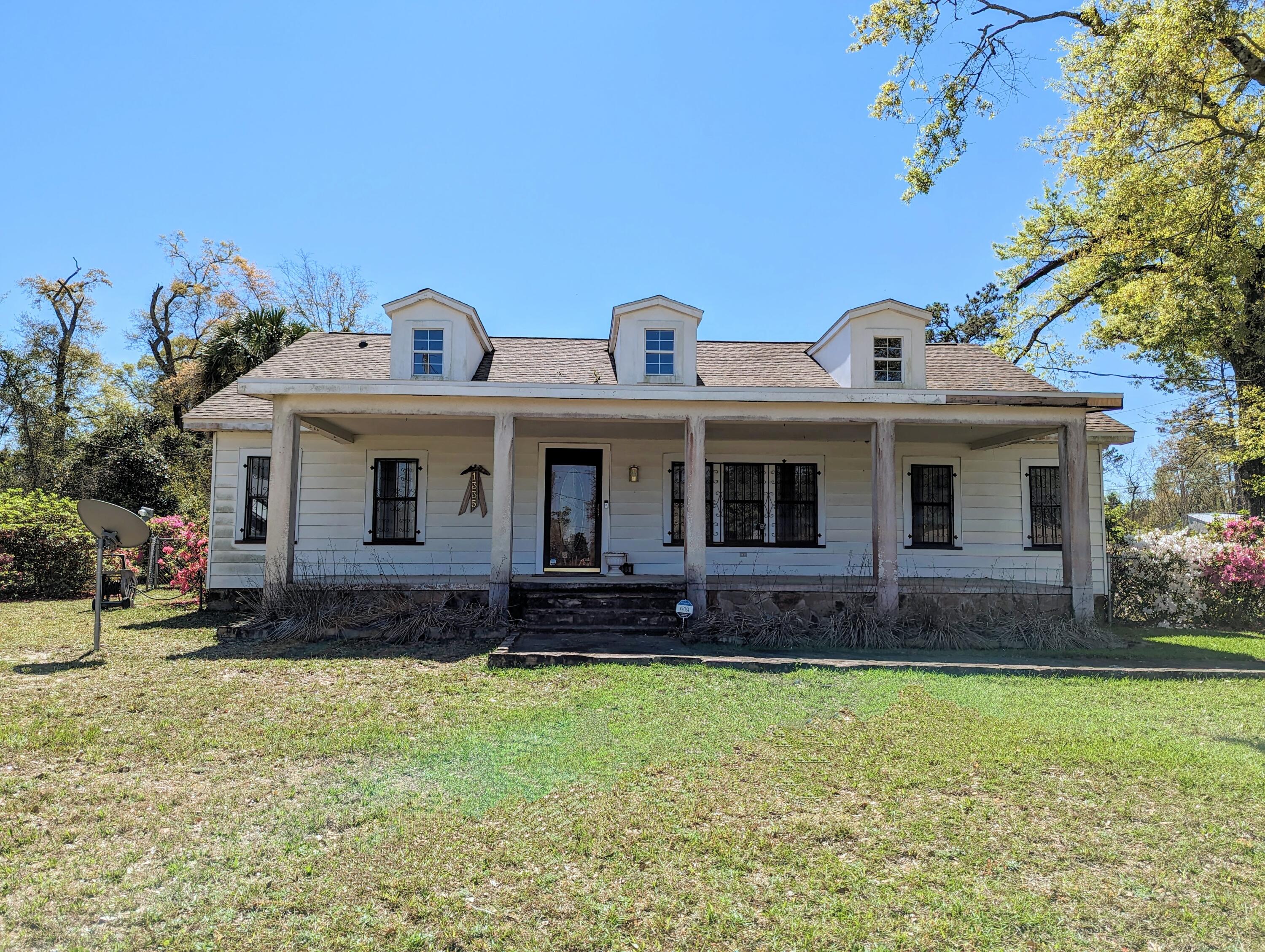 1335 Old Bonifay Road Chipley, FL 32428 - Photo 2 of 31 a front view of a house with a yard