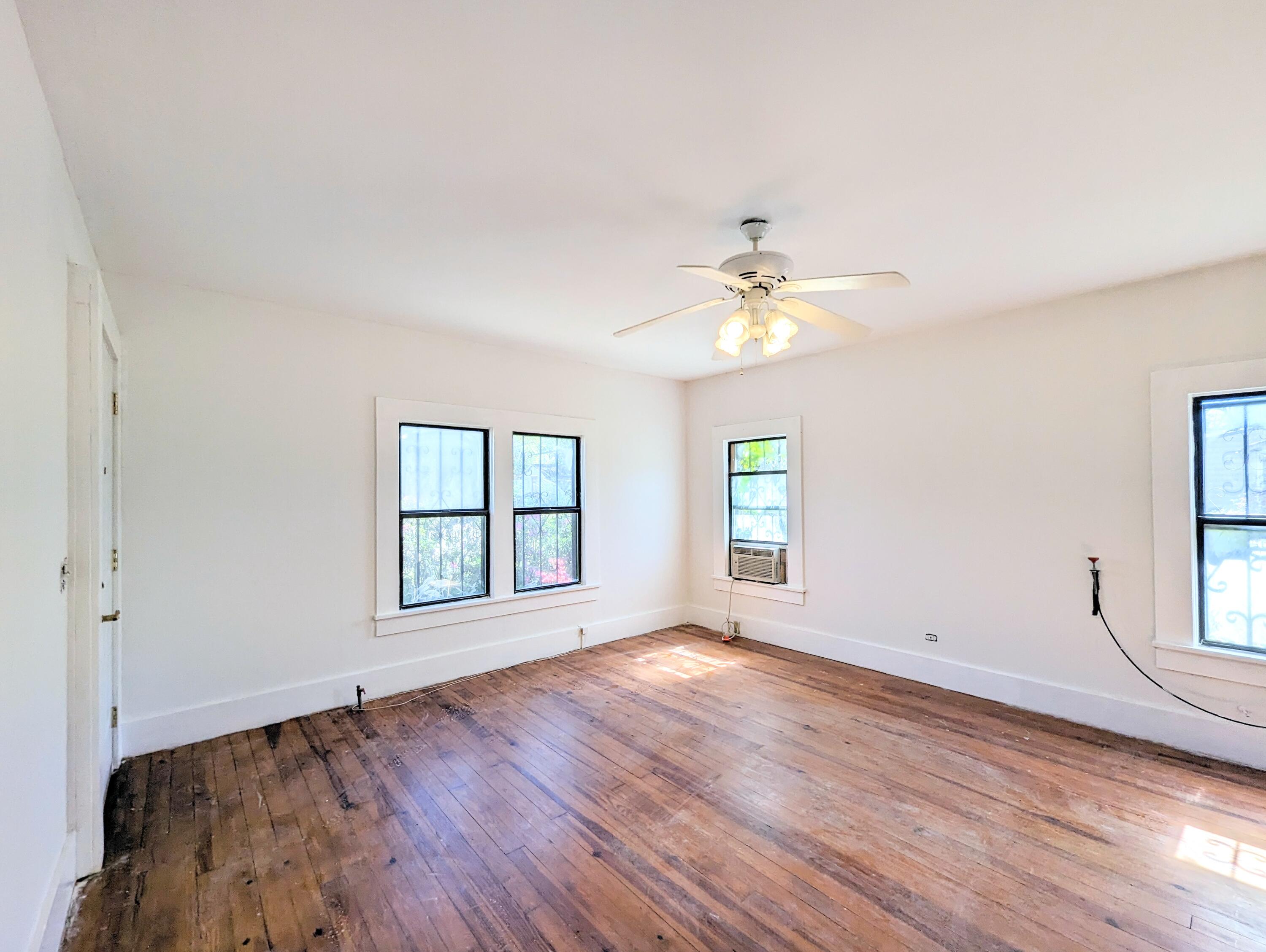1335 Old Bonifay Road Chipley, FL 32428 - Photo 27 of 31 an empty room with wooden floor and windows