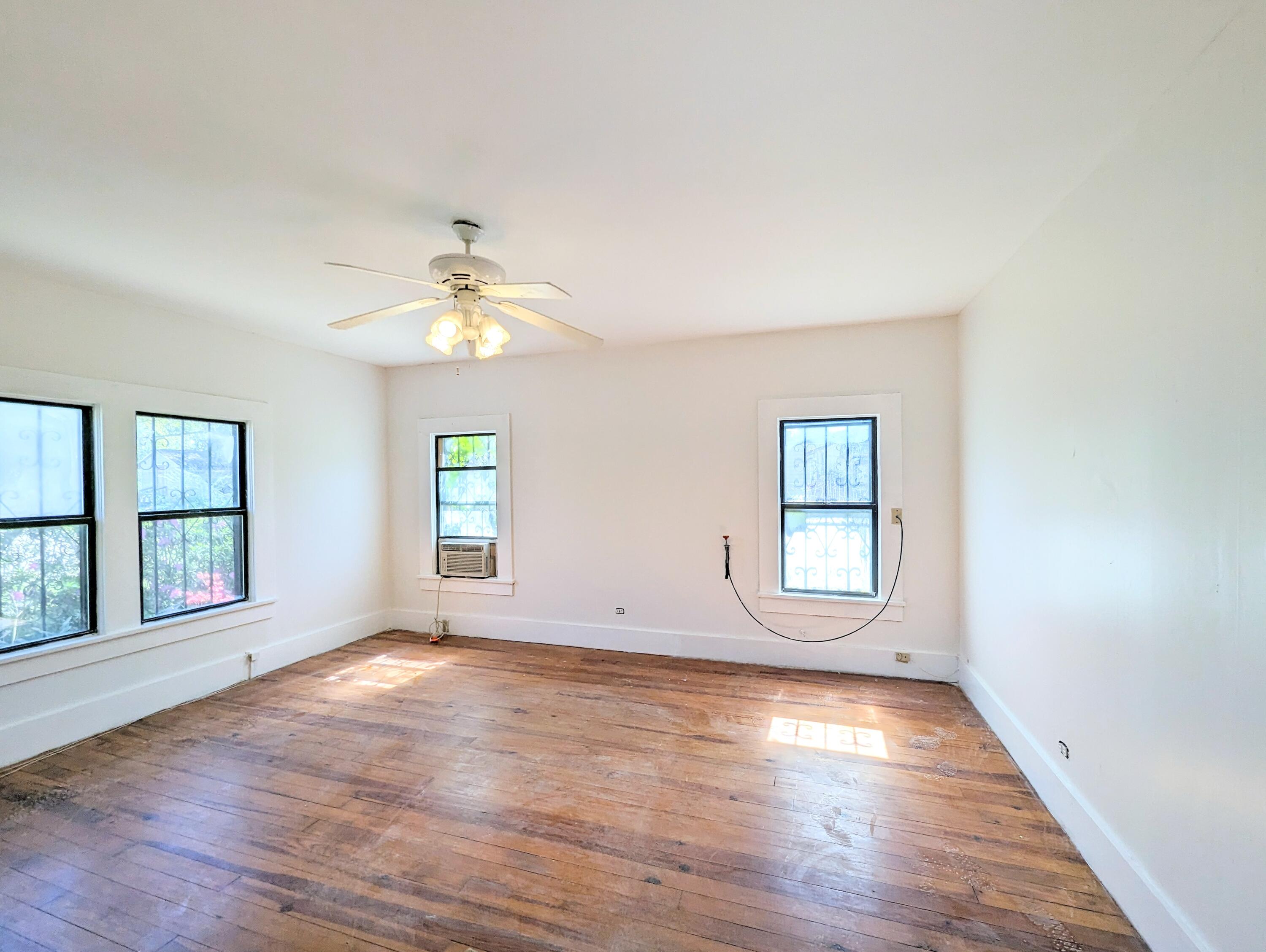 1335 Old Bonifay Road Chipley, FL 32428 - Photo 28 of 31 an empty room with wooden floor and windows