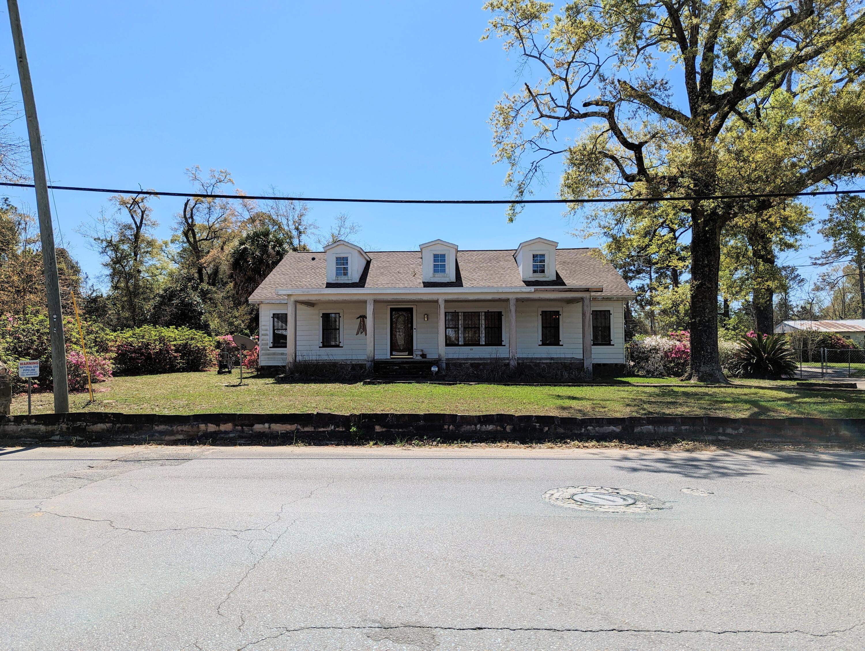 1335 Old Bonifay Road Chipley, FL 32428 - Photo 3 of 31 a front view of house with yard and trees in the background