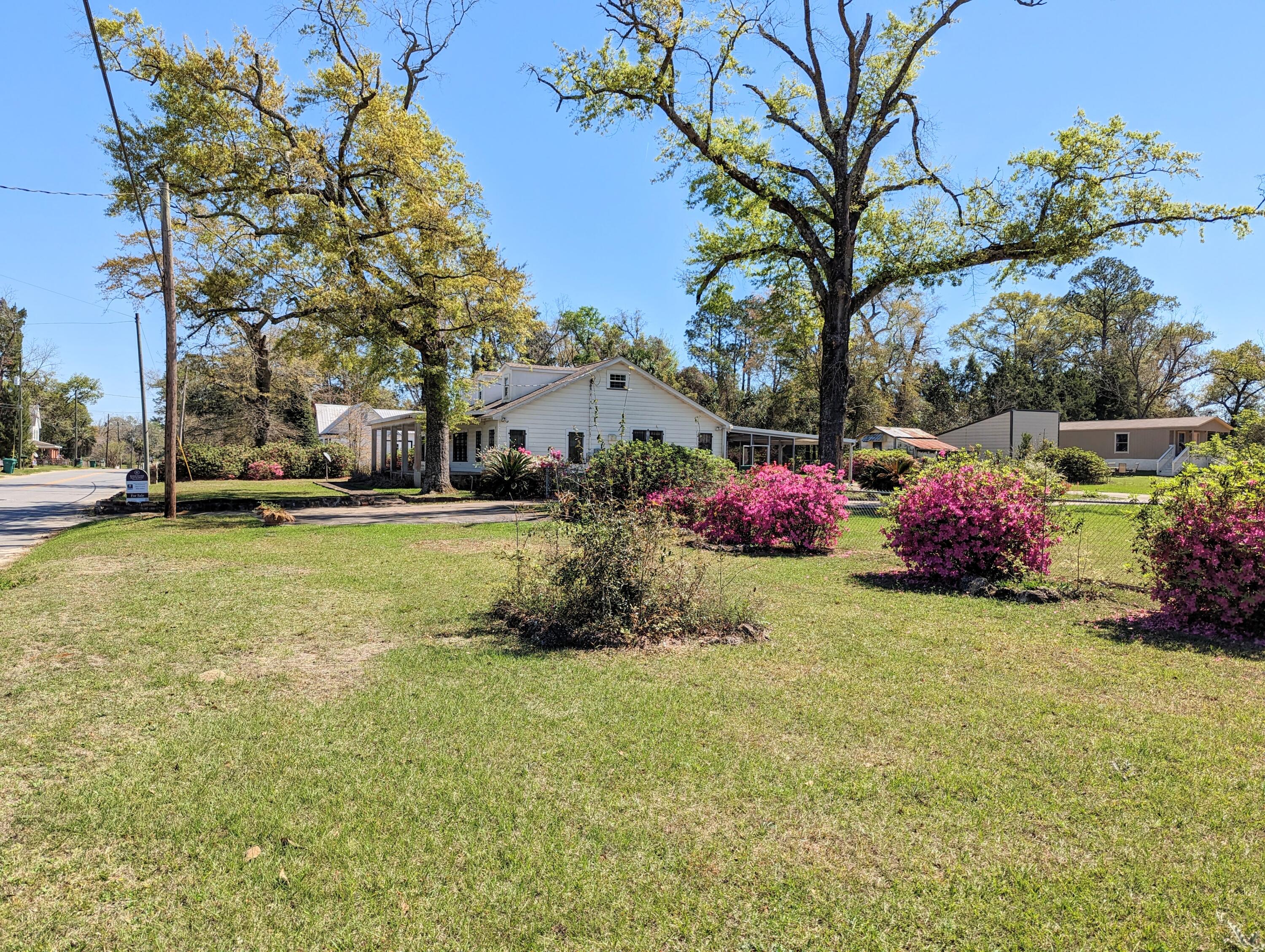 1335 Old Bonifay Road Chipley, FL 32428 - Photo 8 of 31 a front view of a house with garden