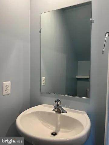 a bathroom with a sink and mirror