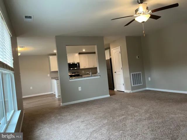 a view of a kitchen with a sink and a refrigerator
