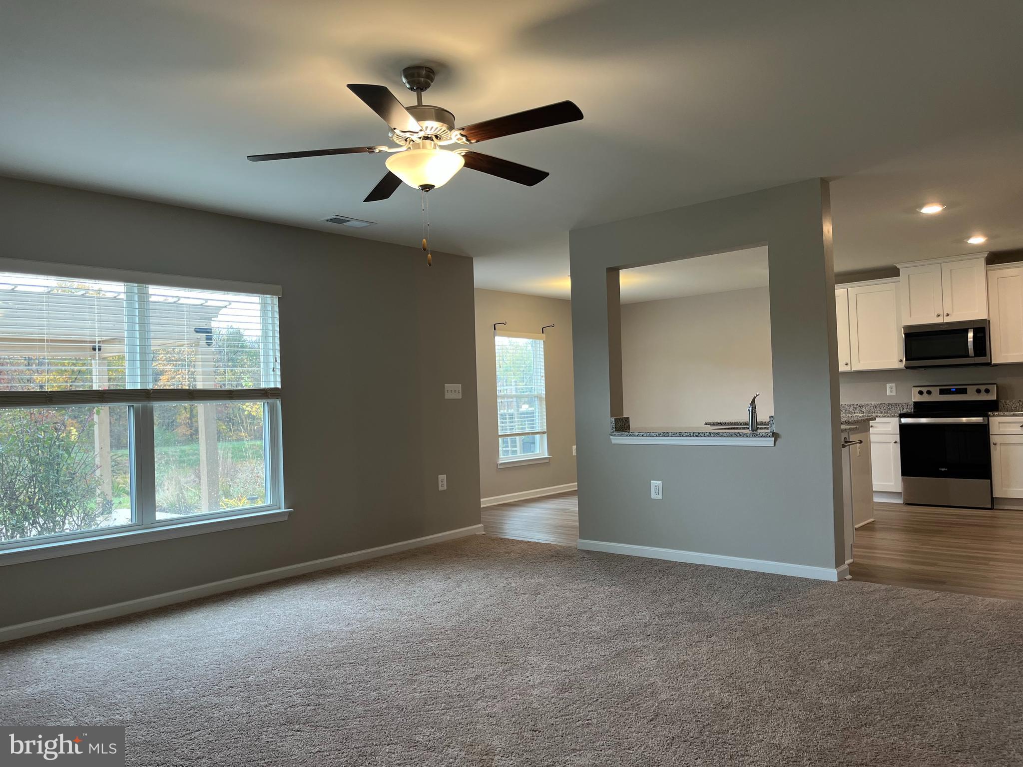 104 Rappahannock Run Falling Waters, WV 25419 - Photo 14 of 54 a view of an empty room with a window and kitchen view