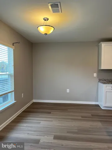 a view of a kitchen with wooden floor and a sink