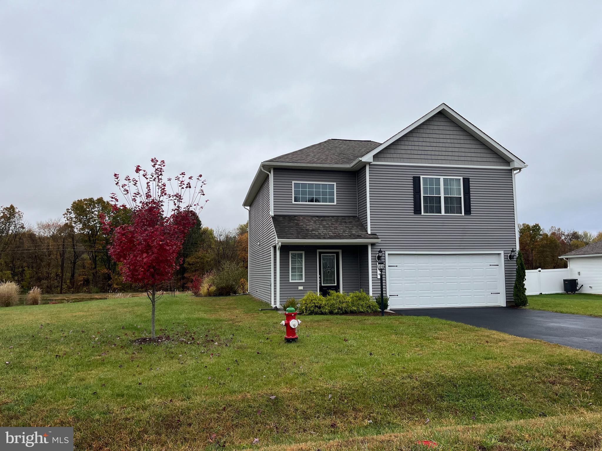 104 Rappahannock Run Falling Waters, WV 25419 - Photo 3 of 54 a front view of a house with a yard and garage