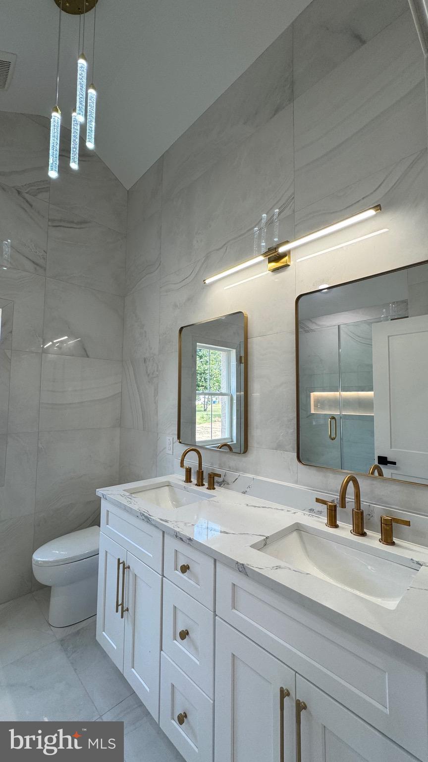 350 Honeymoon Road Glassboro, NJ 08028 - Photo 11 of 23 a bathroom with a double vanity sink toilet and a mirror