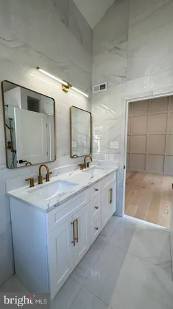 a spacious bathroom with a granite countertop sink a mirror and a
