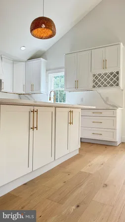 a view of a kitchen with cabinets and wooden floor