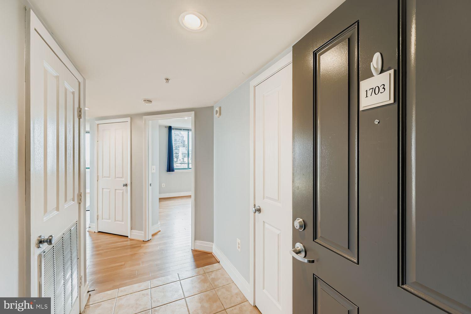 414 Water Street, Unit 1703 Baltimore, MD 21202 - Photo 5 of 34 a view of a hallway with wooden floor and closet area
