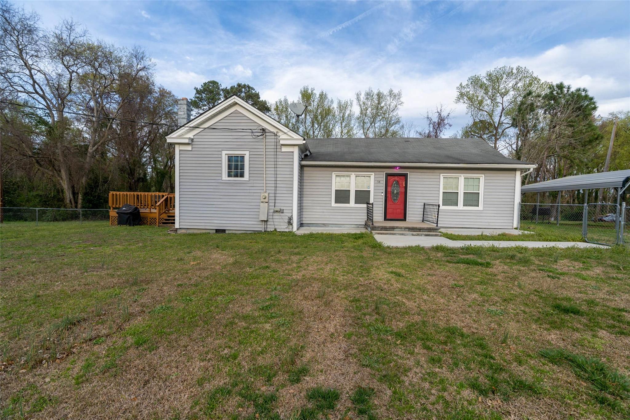 54 Bunker Street Rockingham, NC 28379 - Photo 1 of 22 a house view with a garden and large trees