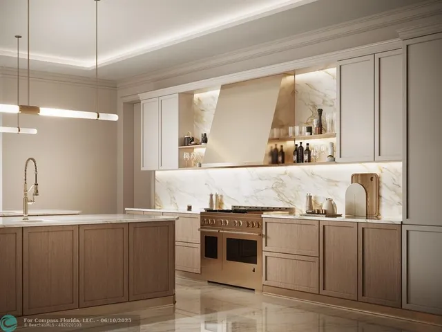 a kitchen with kitchen island granite countertop a sink and white cabinets