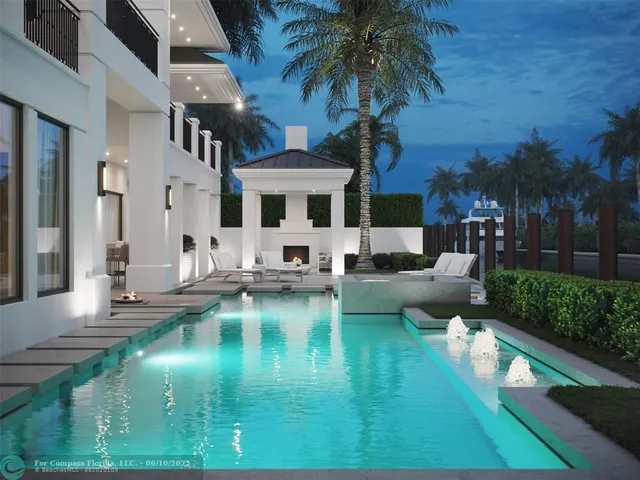 a view of a swimming pool with couches chairs and fire pit