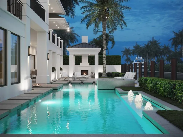 a view of a swimming pool with couches chairs and fire pit
