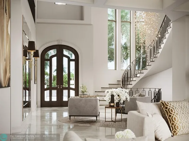 a living room with furniture and floor to ceiling windows
