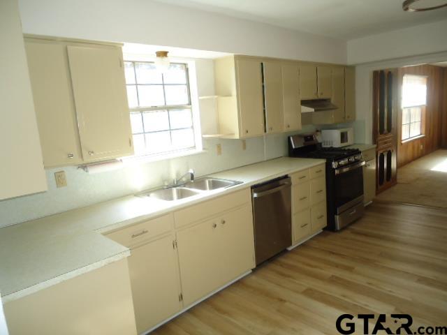 16994-c R 223 C R 223 Arp, TX 75750 - Photo 21 of 38 a kitchen with a sink cabinets wooden floor and stainless steel appliances